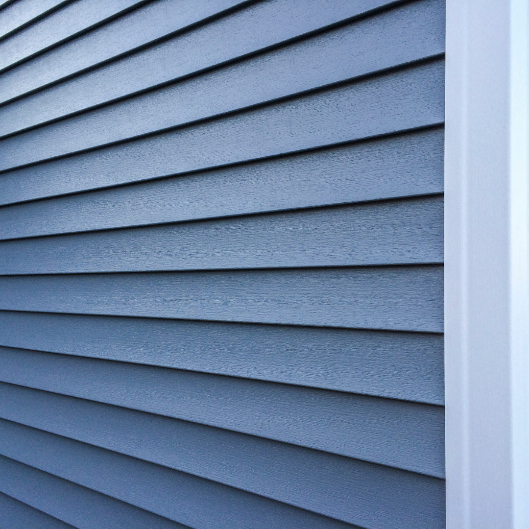 Home exterior featuring newly installed vinyl and composite siding with clean lines and modern, weather-resistant materials.